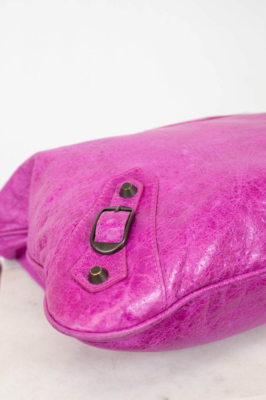 Pink velvet bag with graphite-colored accents on a white background