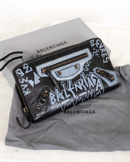 Balenciaga wallet with graffiti design on a gray background