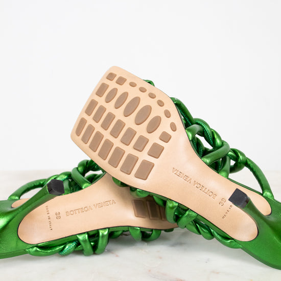 Green sandal with wooden insole on a white background