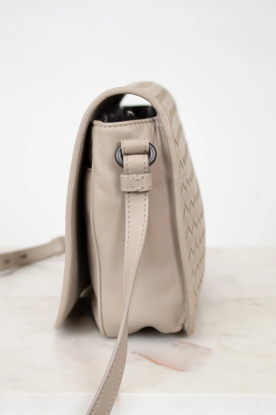 Beige handbag with a strap on a light background