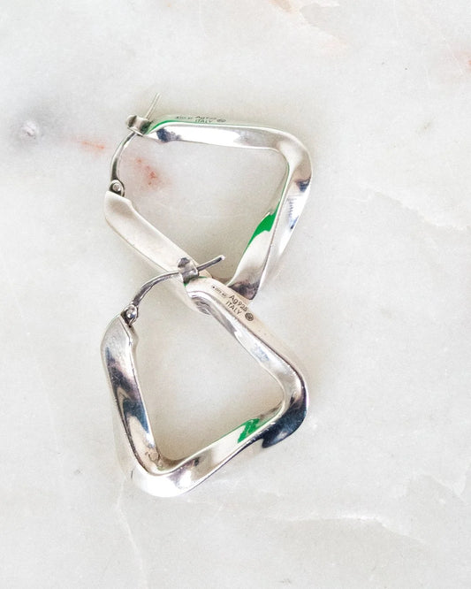 Silver hoop earrings on a light background
