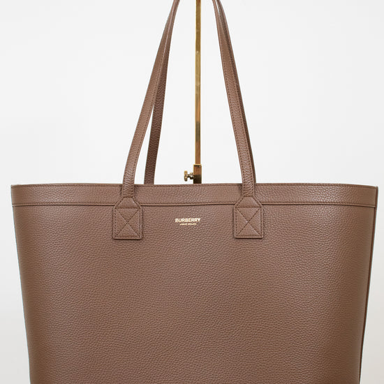 Brown leather tote on white background