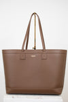 Brown leather tote on white background