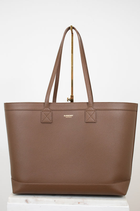 Brown leather tote on white background