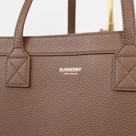 Brown Burberry handbag with visible logo on a light gray background