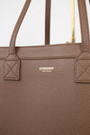 Brown Burberry handbag with visible logo on a light gray background