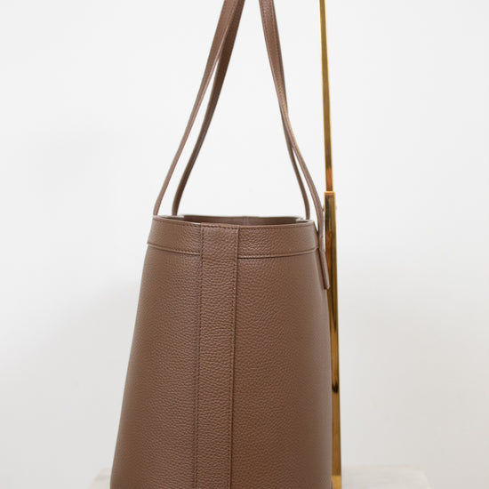 Brown leather handbag on a white background