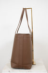 Brown leather handbag on a white background