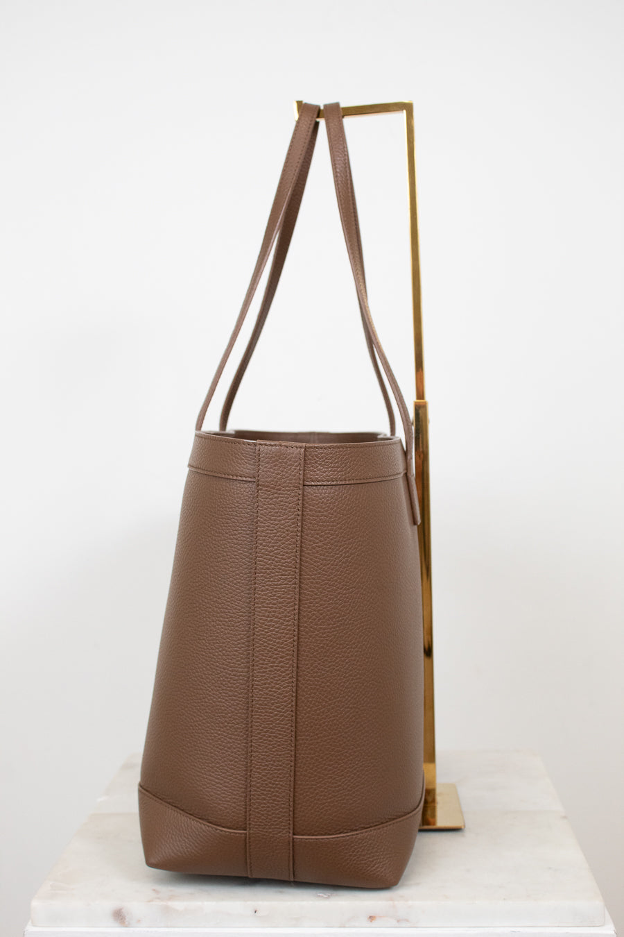 Brown leather handbag on a white background