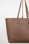 Brown tote bag with a gold zipper on a white background