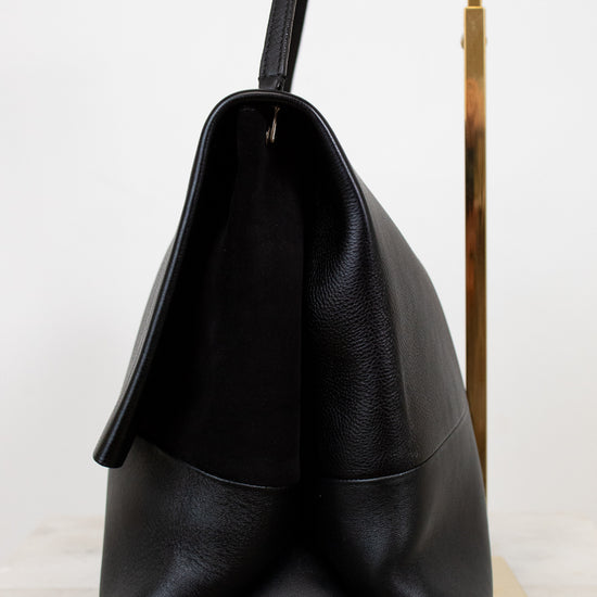 Black leather handbag on a white background