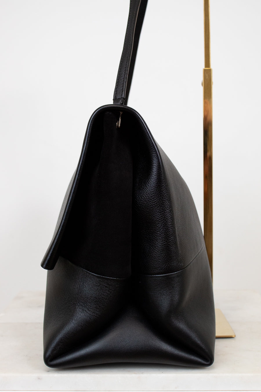 Black leather handbag on a white background