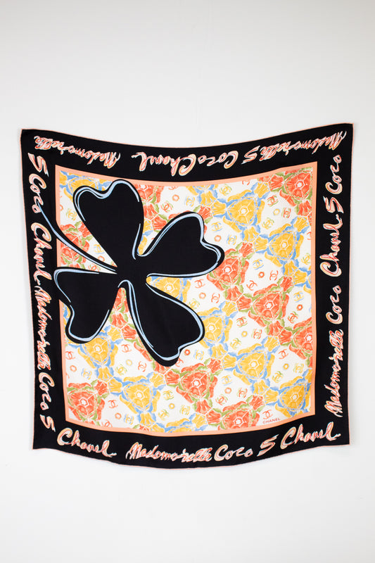 Chanel scarf with large black clover and colorful pattern on white background