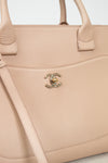 Beige handbag with Chanel logo on a light background