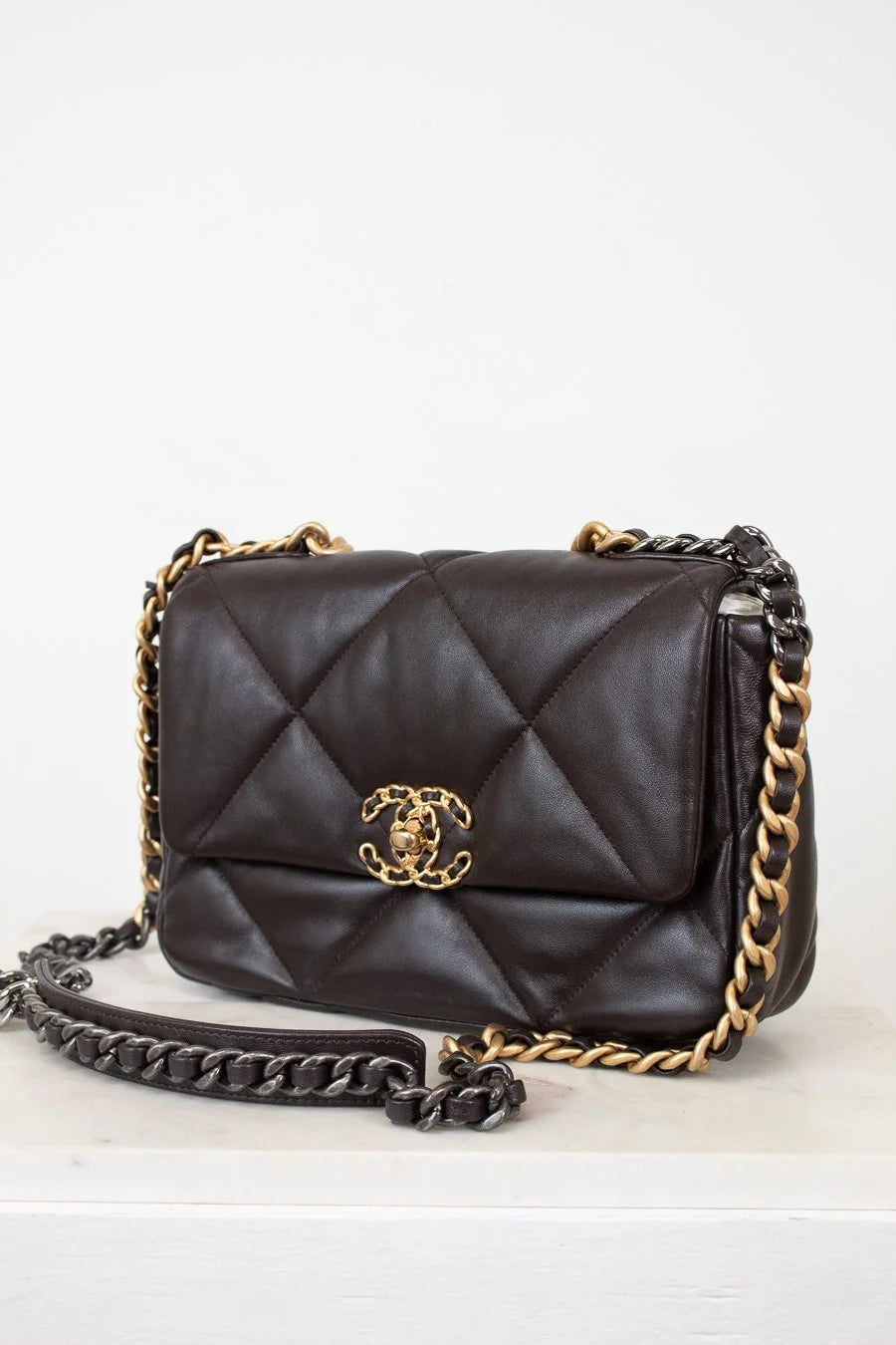 Dark Brown quilted handbag with gold chain strap on a white background