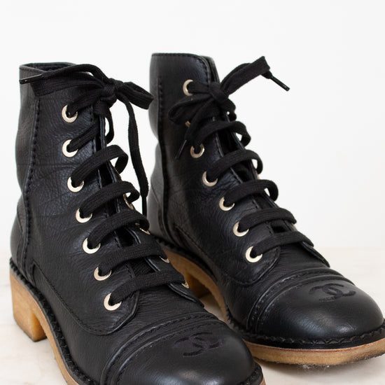 Black combat boots on white background