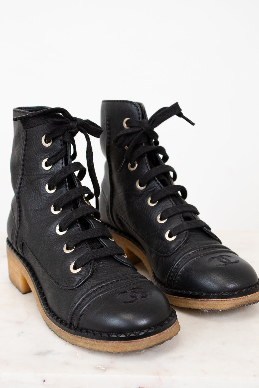 Black combat boots on white background