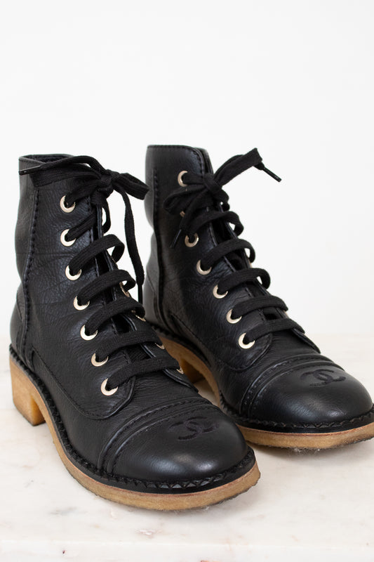 Black combat boots on white background