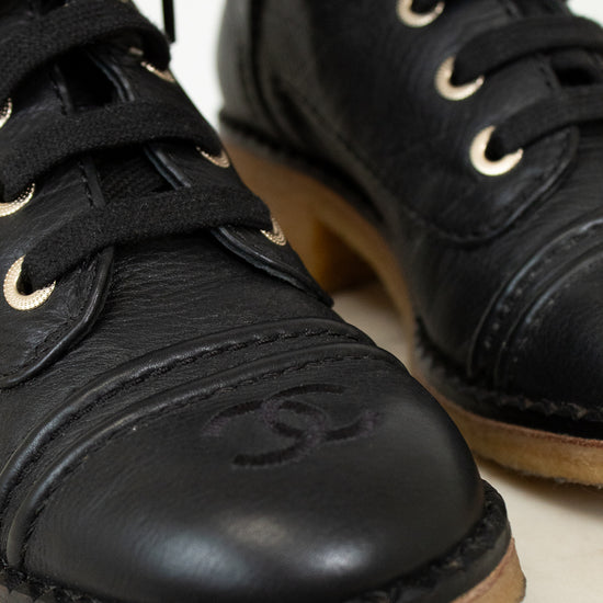 Close up of black boot toe on white background