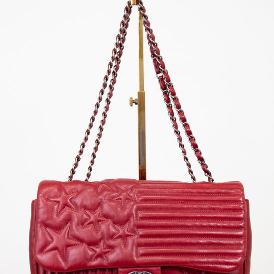 Red Chanel handbag with starts on white background