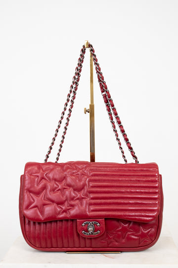 Red Chanel handbag with starts on white background