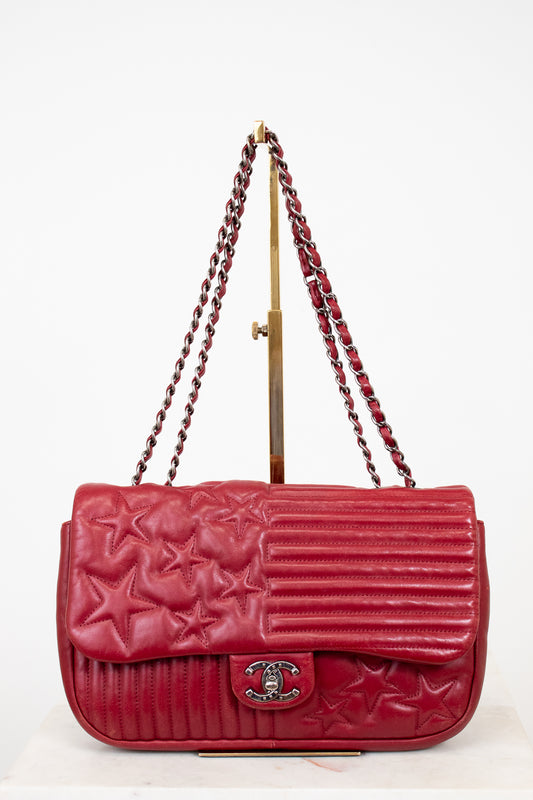 Red Chanel handbag with starts on white background