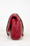 Red handbag with chain detail on a white background