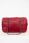 Red leather handbag with a chain strap on a white background