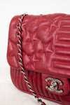 Red quilted star handbag on white background