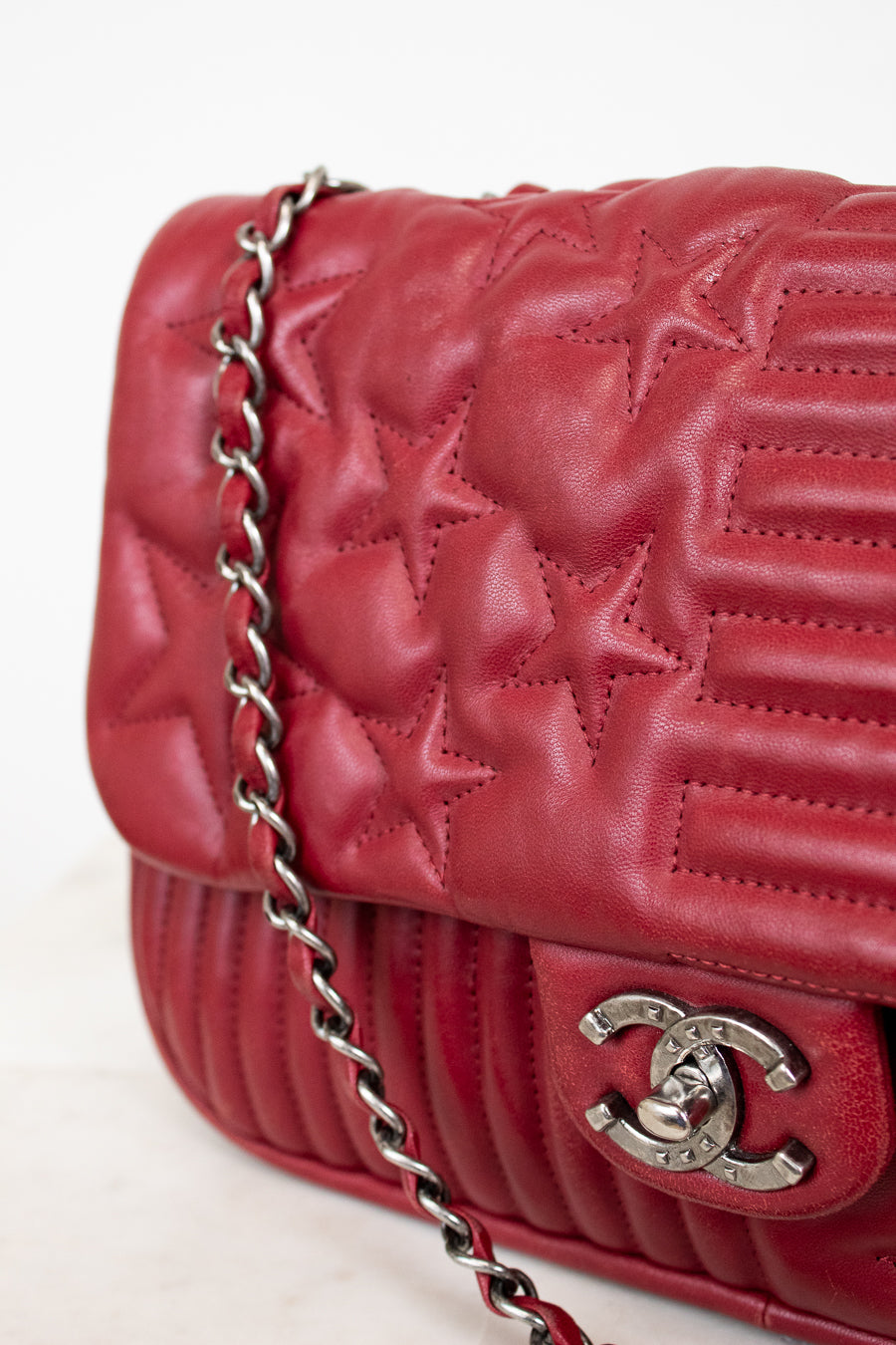 Red quilted star handbag on white background