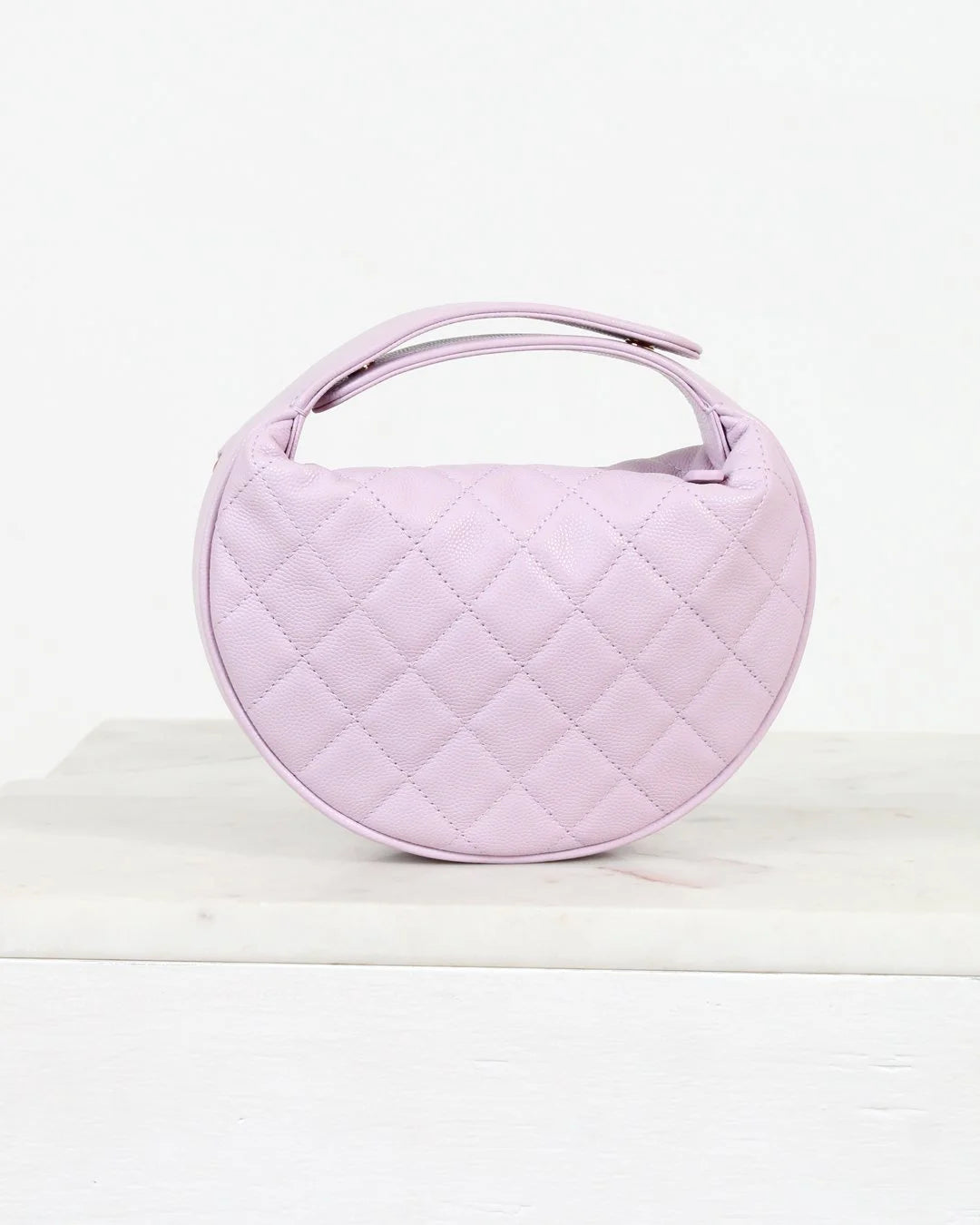 Quilted lavender handbag on a white background