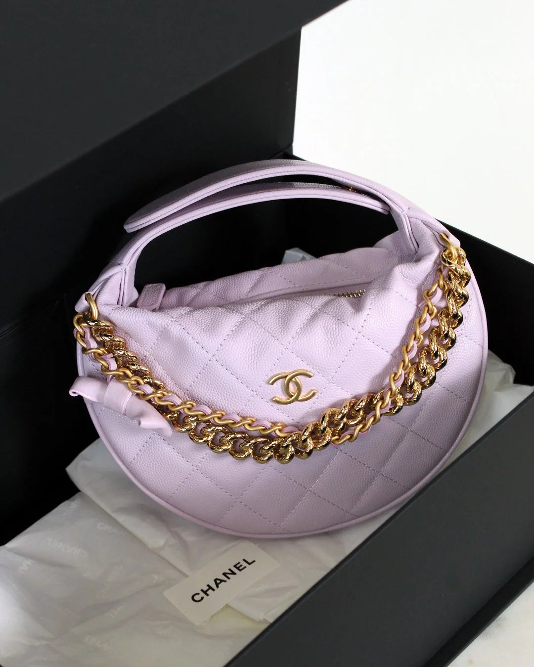 Chanel handbag with gold chain on a white background
