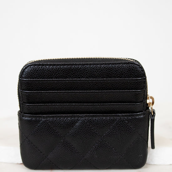 Black quilted wallet on a white background