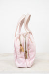 Pink drawstring bag with gold zipper on a white background