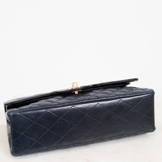 Navy quilted handbag on a white background