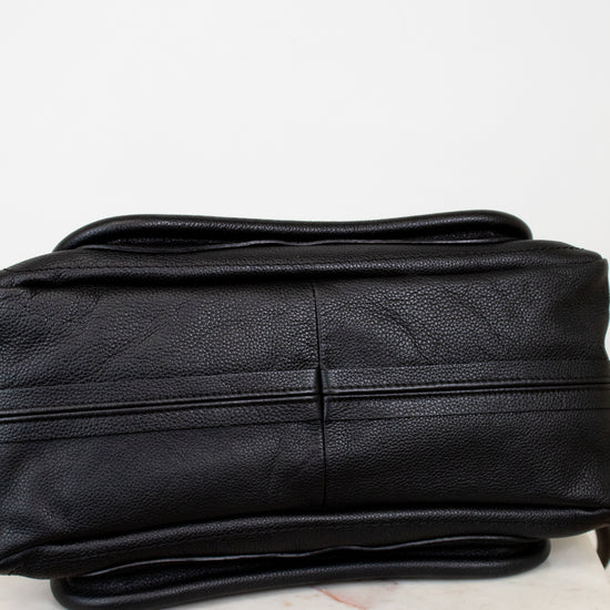 Black leather purse on a light gray background