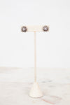 Earrings on earrings stand on a white background