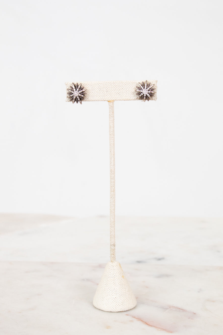 Earrings on earrings stand on a white background