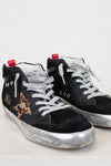 Black sneakers with white laces and a leopard print star on a light gray background