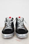 Black high-top sneakers with silver soles on a light background
