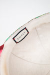 Gucci label on interior of hat with a white background