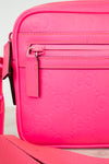 Pink crossbody bag with Gucci logo pattern on a white background
