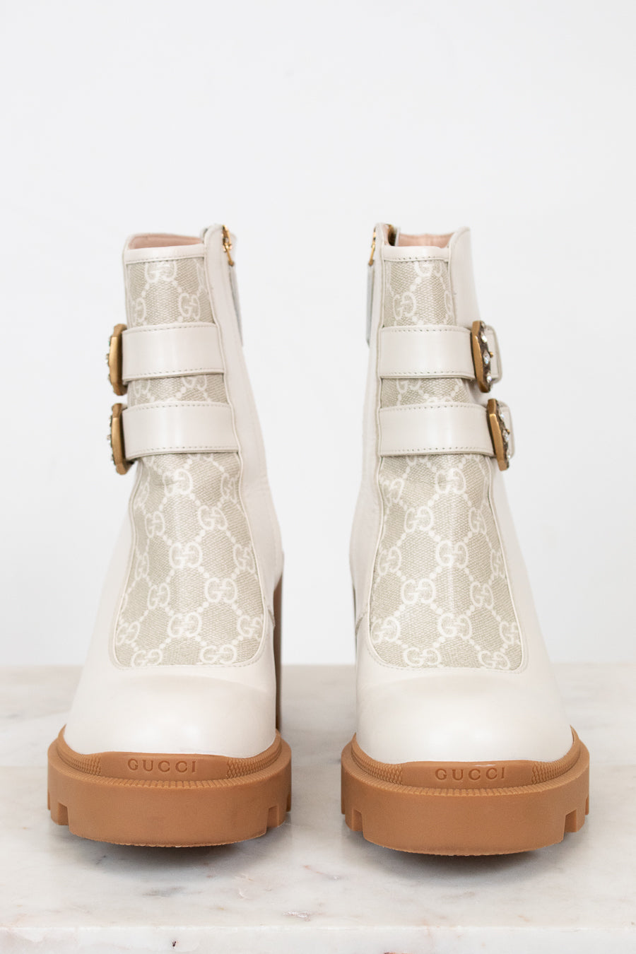 Gucci cream boots with platform tan sole on white background