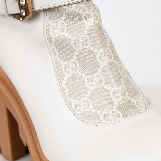 White boot with lace detail and brown block heel on a white background