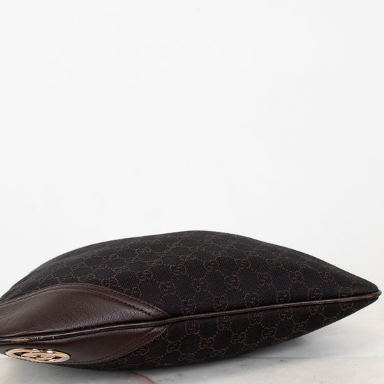 Bottom of brown Gucci purse on a white background