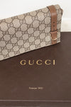 Gucci handbag with brown strap on a Gucci branded box