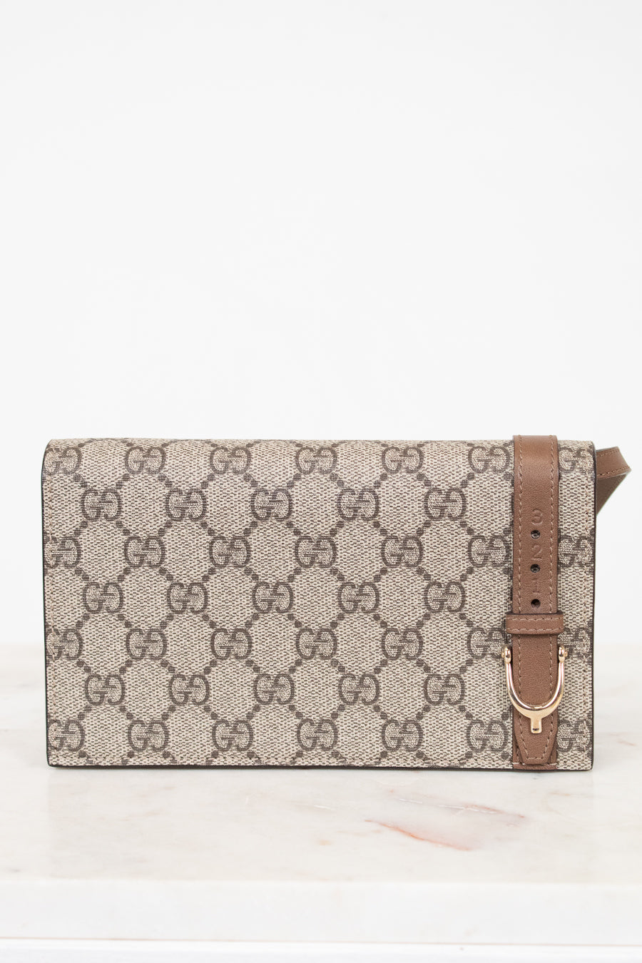 Designer handbag with a prominent brand logo on a white background