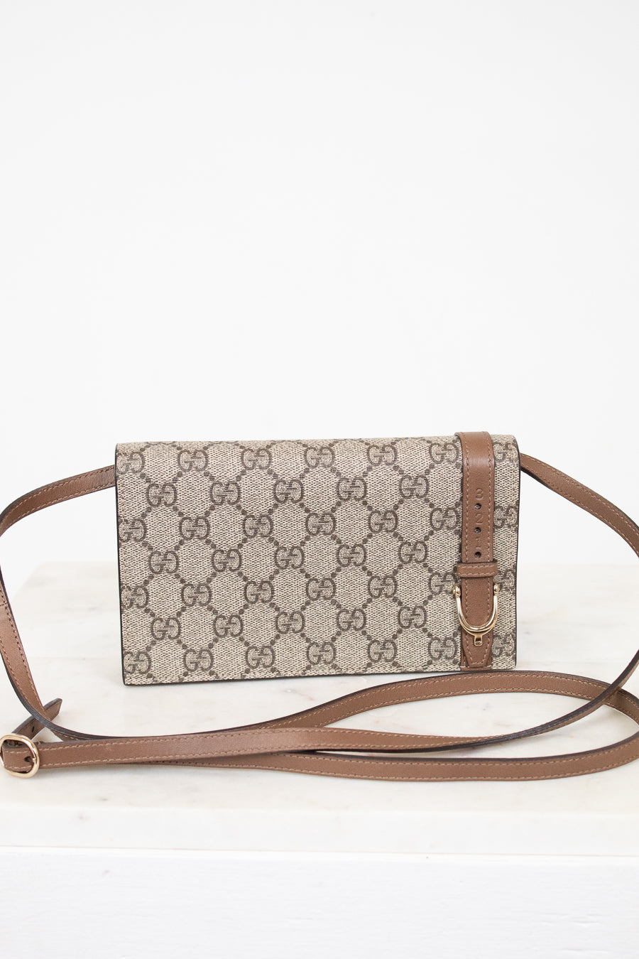 Gucci brown monogram crossbody on white background