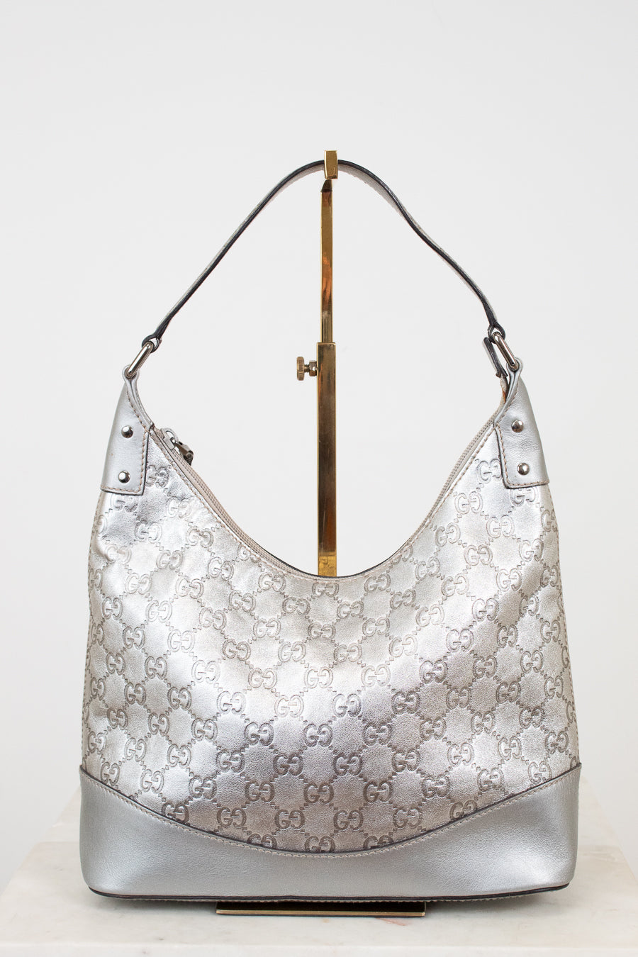 Silver Gucci handbag on a white background