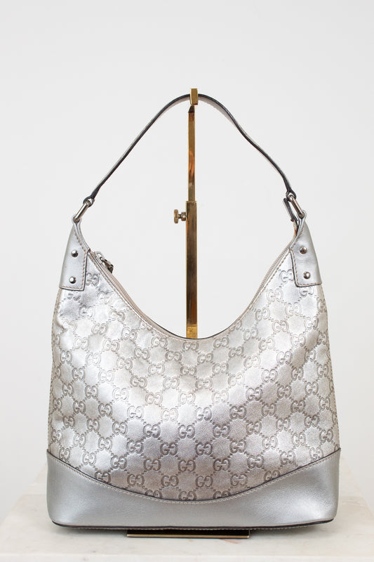 Silver Gucci handbag on a white background